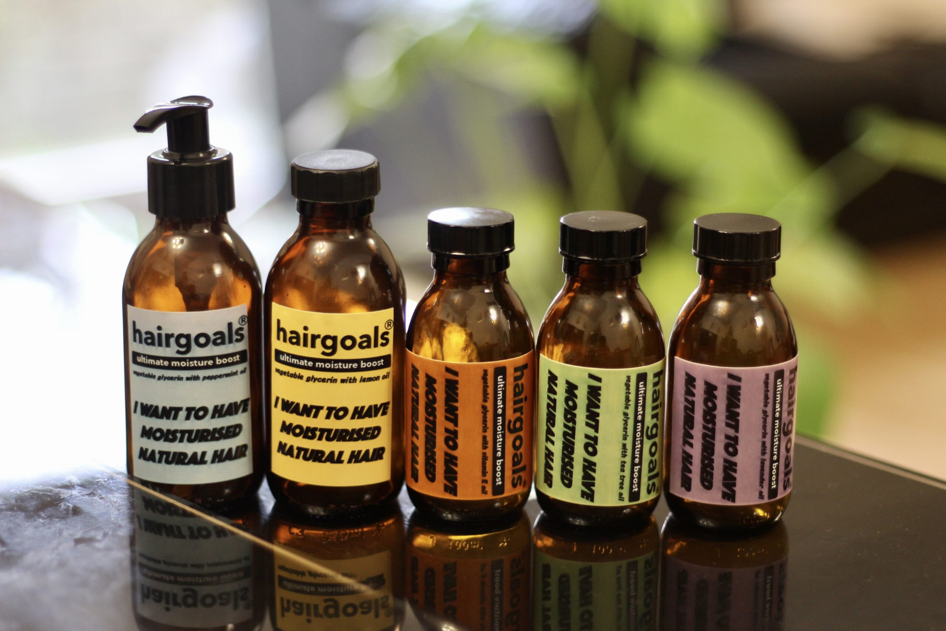 hairgoals mini lemon ultimate moisture boost beside the lavender, vitamin E, peppermint and tea tree glycerin bottles